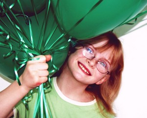 Happy Girl With Green Party Balloons